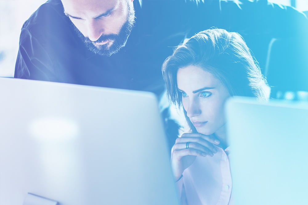 Two individuals collaborating on a computer task