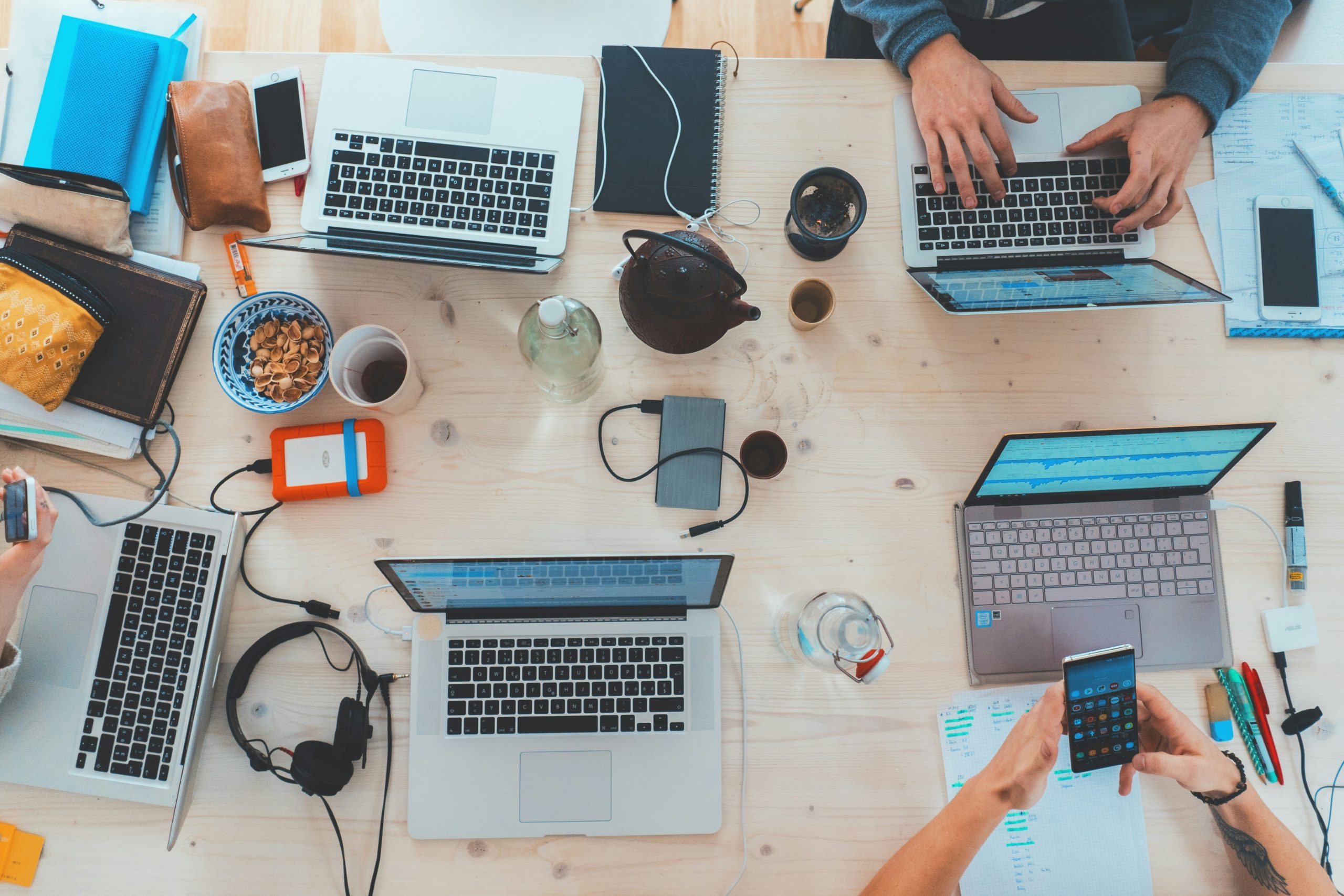 people using laptops on a desk
